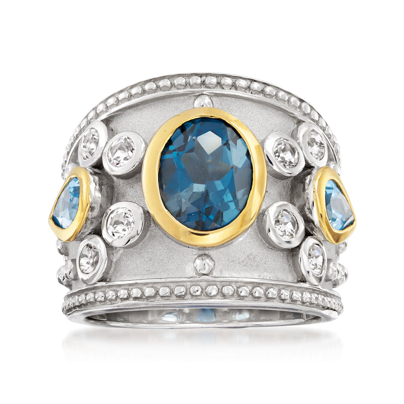 Sterling silver ring with oval London blue topaz centerpiece, gold bezel, and side stones