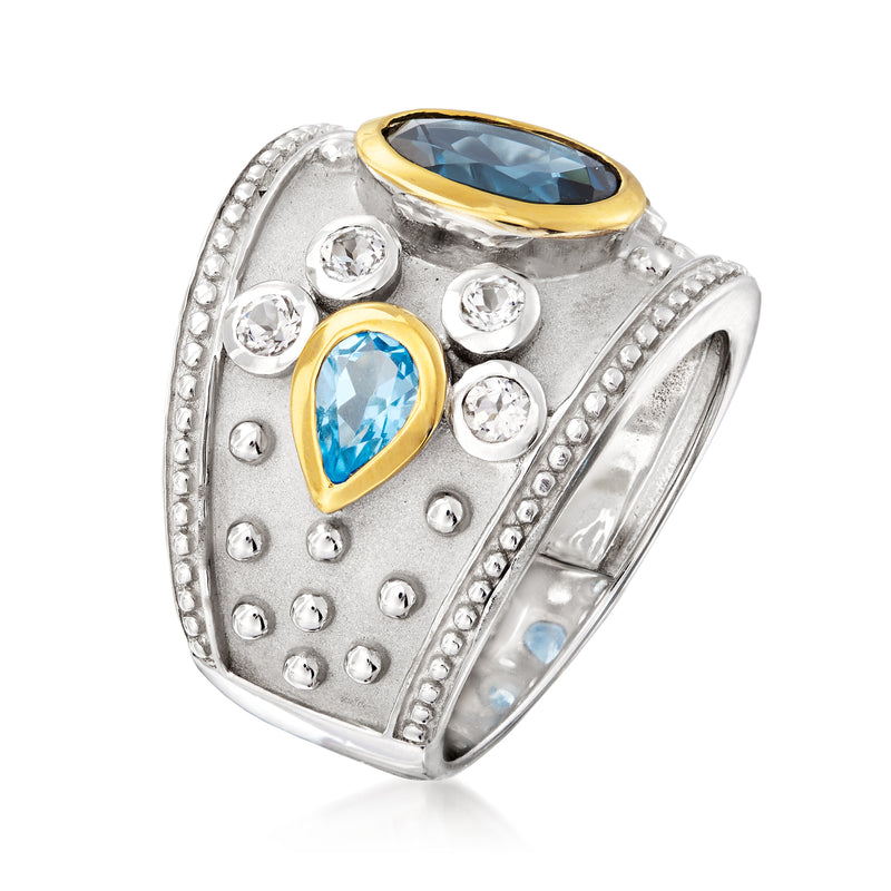 Sterling silver ring with large oval blue gemstone, gold accents, and round white stones