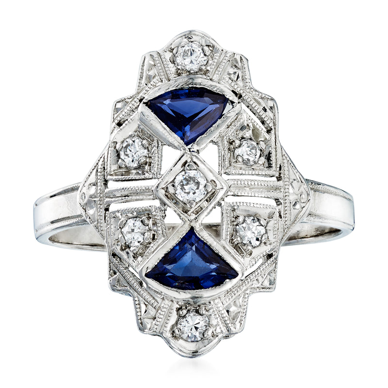 Vintage platinum ring with blue sapphire center stone and diamond accents