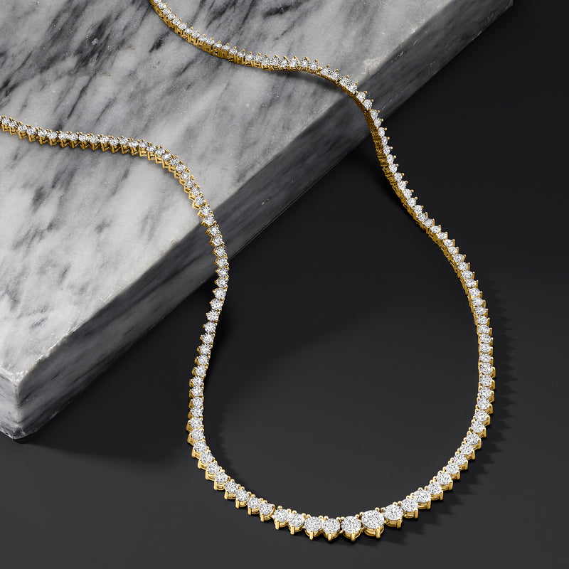 Diamond tennis necklace featuring a full curve of round stones on a gold chain