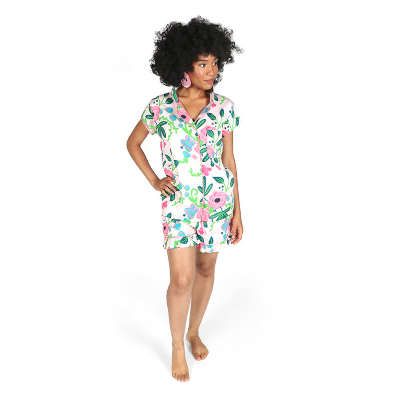 Ruffled summer pajama set with short-sleeve button top and floral shorts, white with pink/green.