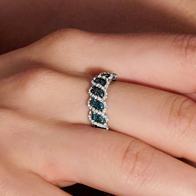 Sterling silver ring on finger with three blue oval stones and white sparkle halos
