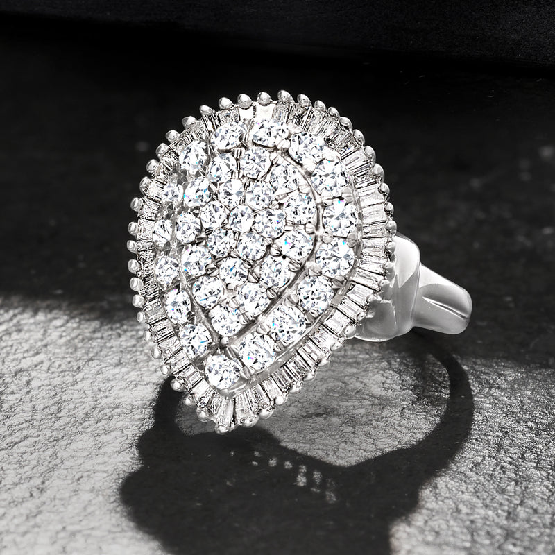 White gold diamond cluster ring with pear-shaped center and diamond halo