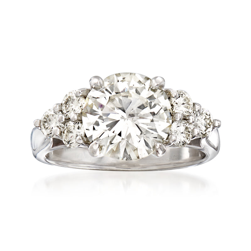 18kt white gold diamond ring with large round center stone and small side diamonds on band