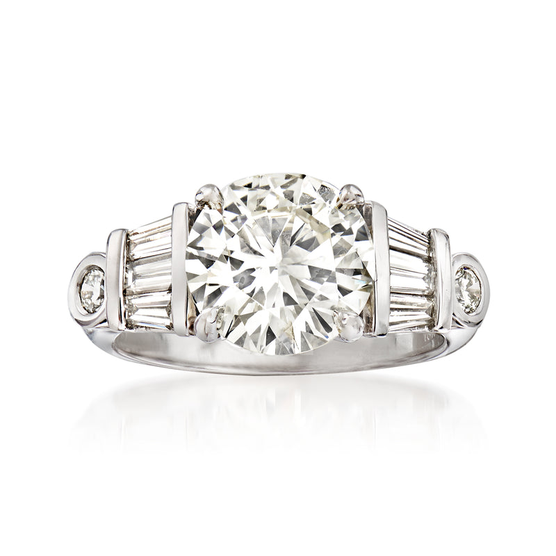 18kt white gold diamond ring with large round center stone and baguette side stones