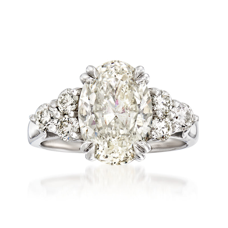 18kt white gold diamond ring with round center stone and multi-row halo