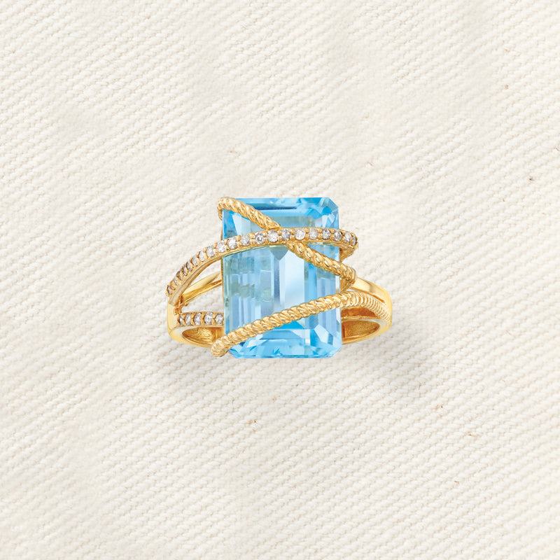 14kt yellow gold ring featuring sky-blue topaz with diamond halo and lattice bars