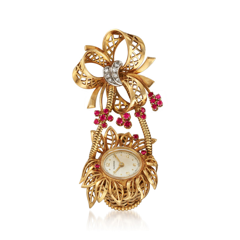 Vintage yellow gold watch pin with openwork flower basket, ruby-red stones, and small round dial