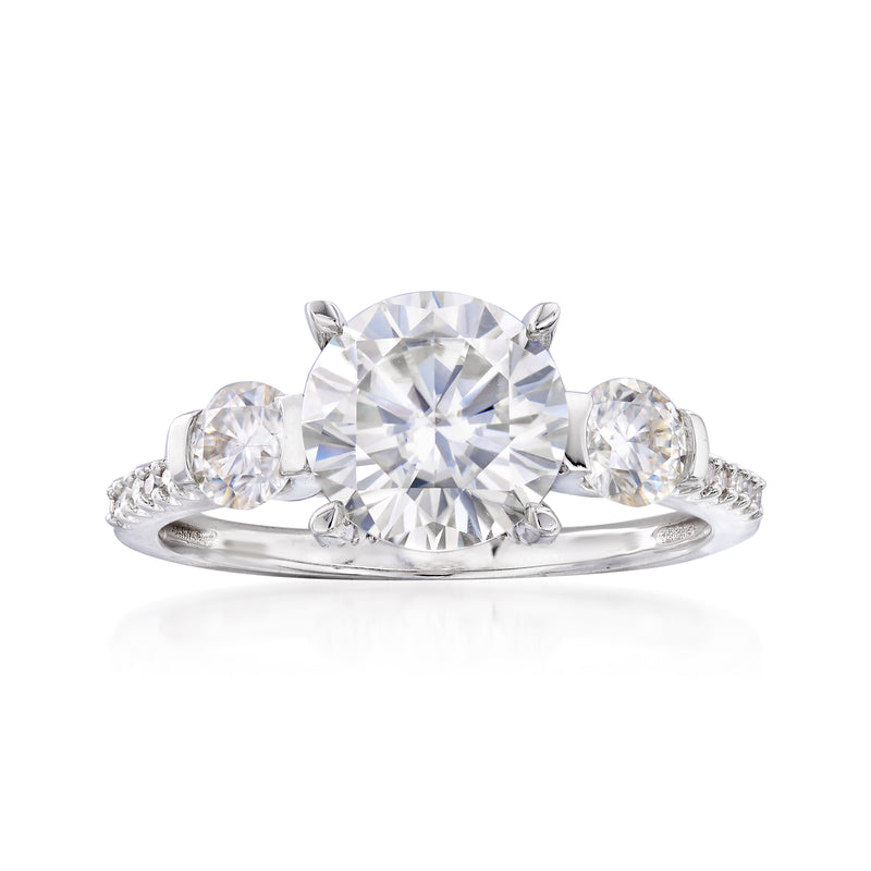 14k white gold three-stone engagement ring with round moissanite center and side diamonds