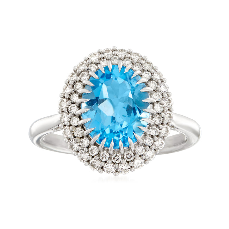 Oval blue topaz ring with diamond halo and pave setting on 14kt white gold band