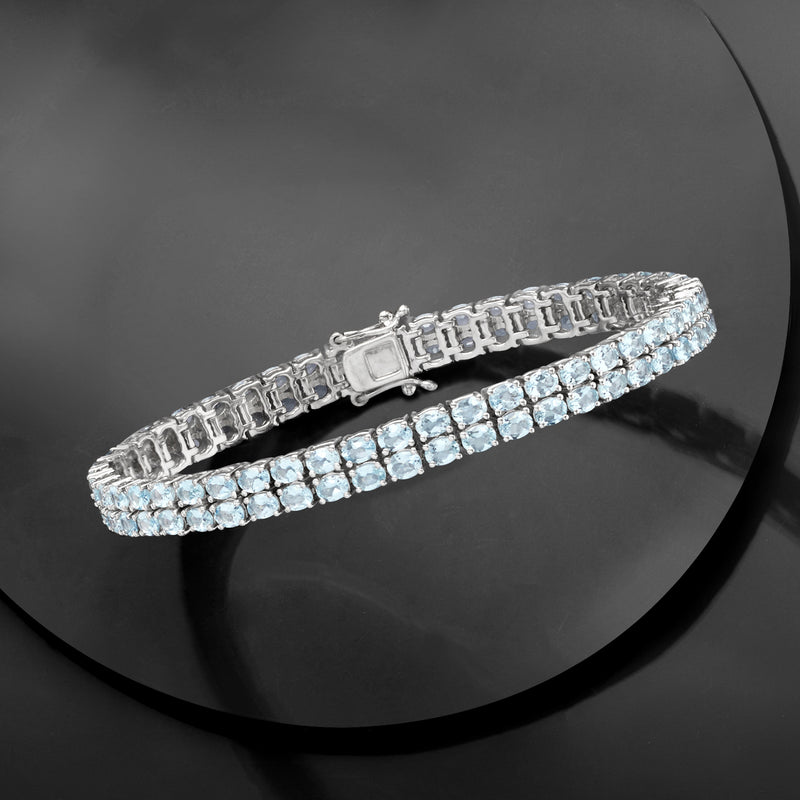 Sterling silver two-row tennis bracelet with round light blue aquamarine stones, side view