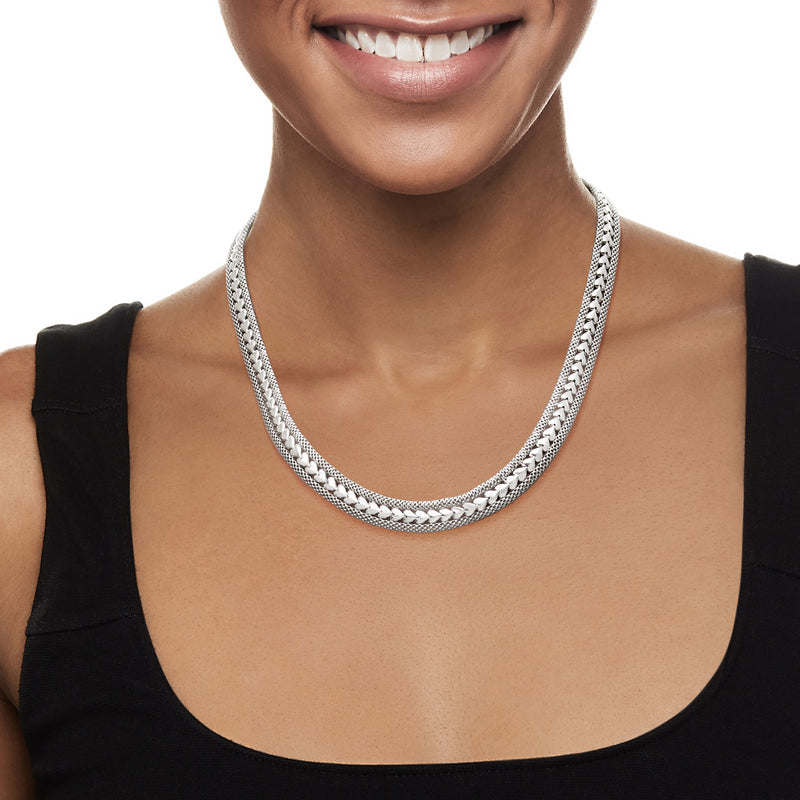 Sterling silver chain necklace with textured links, worn at the neckline