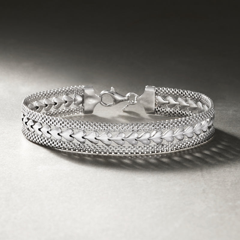 Sterling silver heart-motif bracelet with textured chain links and fold-over clasp