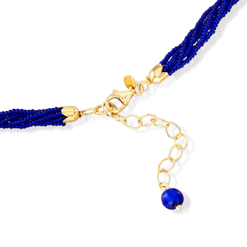 Blue bead necklace with gold clasp, extender chain, and small round blue glass charm