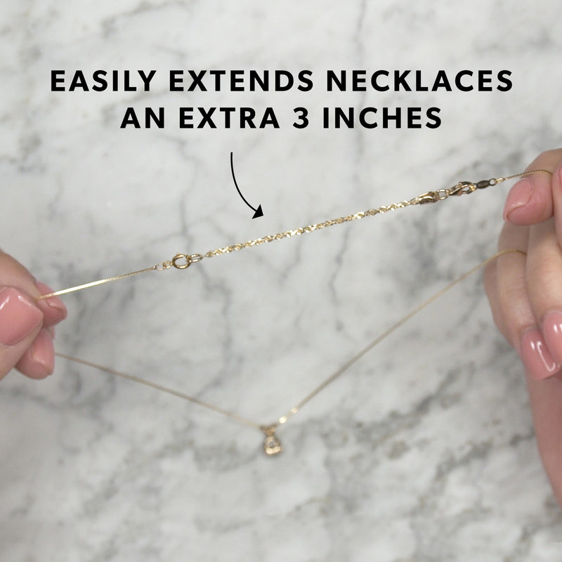 Yellow gold rope-chain necklace extender links with lobster clasp, shown being held