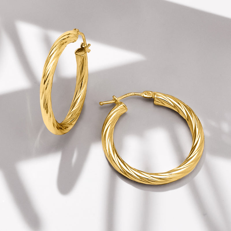 Twisted yellow gold hoop earrings with post back and clasp detail