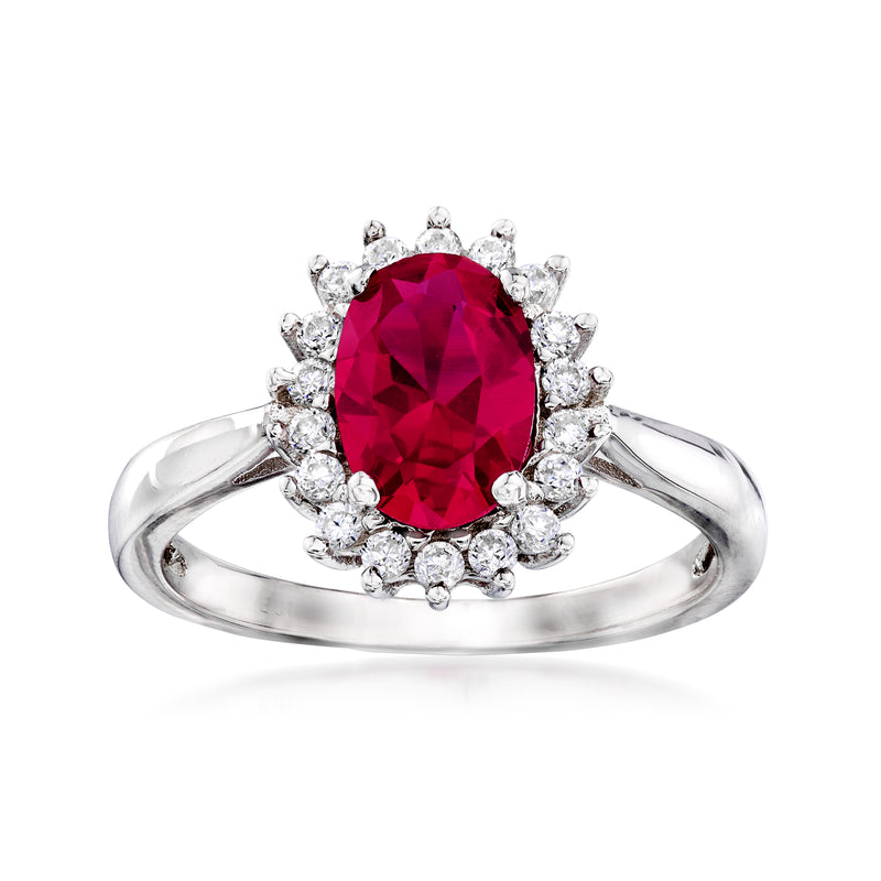 Sterling silver halo ring with oval red simulated ruby center and clear CZ side halo
