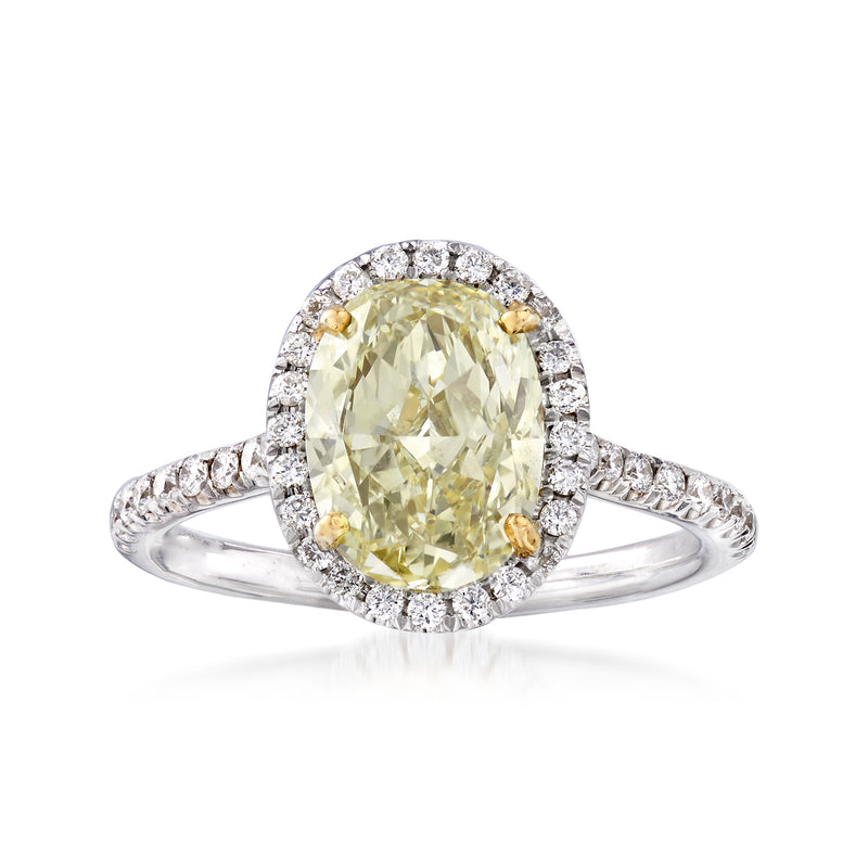 Oval yellow diamond halo ring with white diamond cluster, 18kt two-tone gold setting
