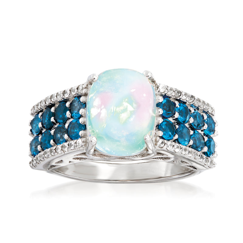 Sterling silver ring with oval opal center, blue topaz sides, and pave white zircon accents