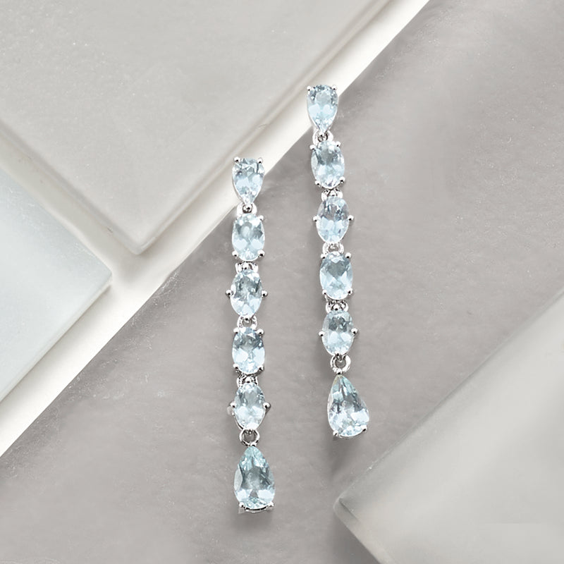 Aquamarine linear drop earrings in sterling silver, side view with teardrop stones
