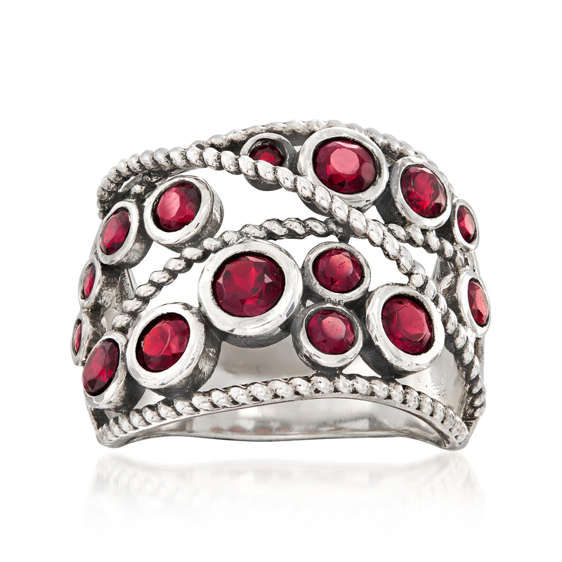 Sterling silver garnet ring with round red stones in a braided halo design
