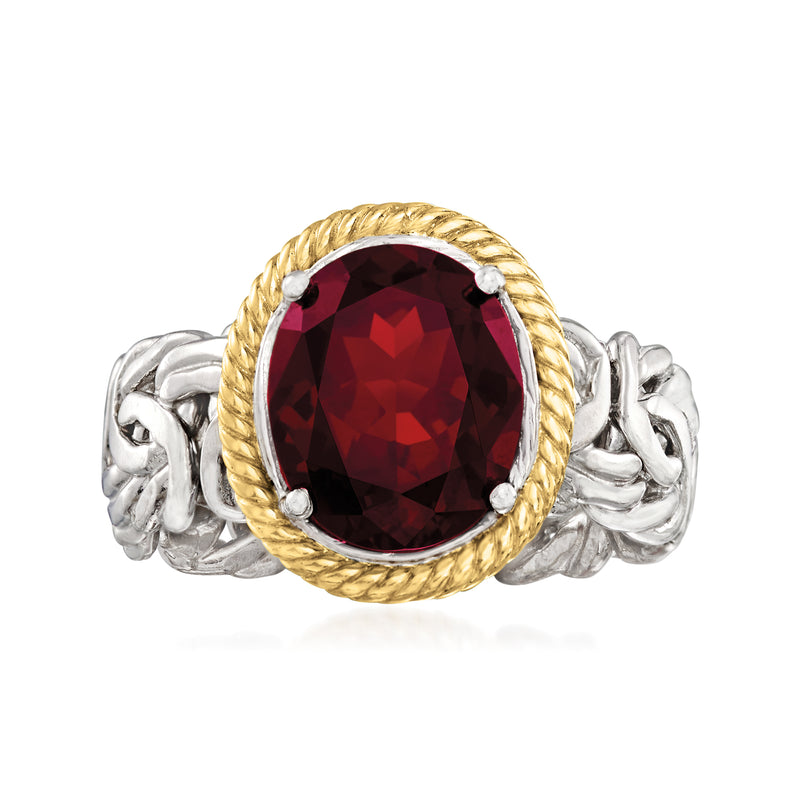 Oval garnet centerpiece ring with braided gold bezel and silver Byzantine band