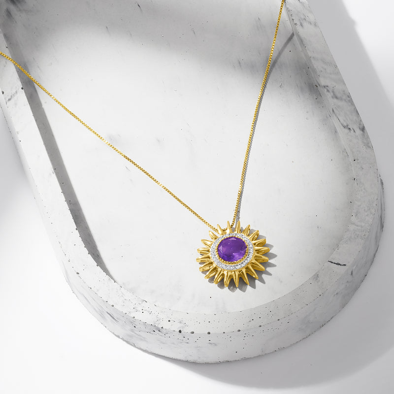 Gold sun pendant necklace featuring a purple amethyst set in a radiant sun design