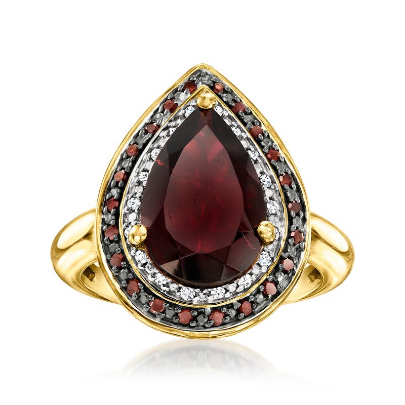 18kt gold over sterling ring with oval red garnet center, diamond halo and prong settings