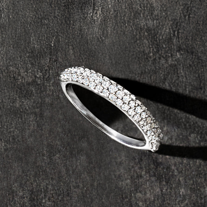 Sterling silver pave diamond ring, profile view; bright stone-set band.