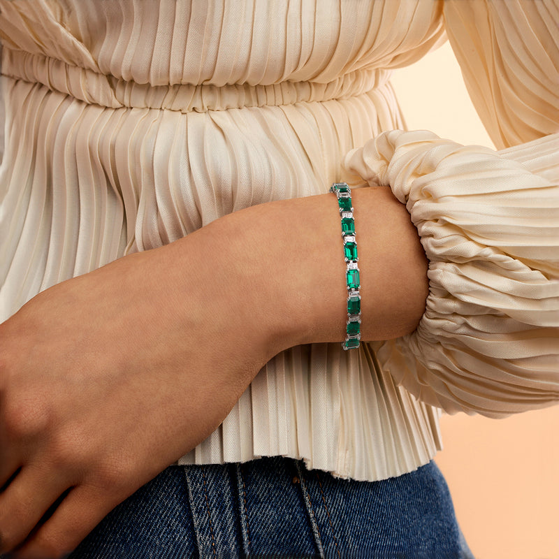 Sterling silver bracelet with green rectangular stones worn on wrist