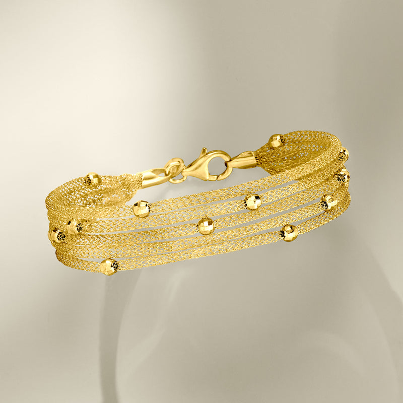 Gold-toned multi-strand mesh bracelet with toggle clasp and stacked chain strands