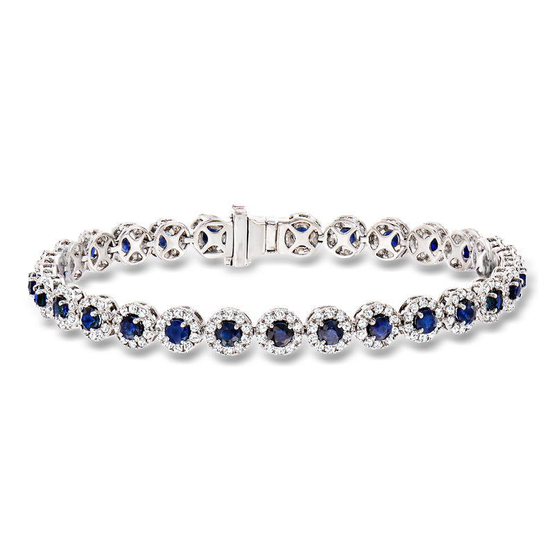 14kt white gold tennis bracelet with oval blue sapphires and diamond halos