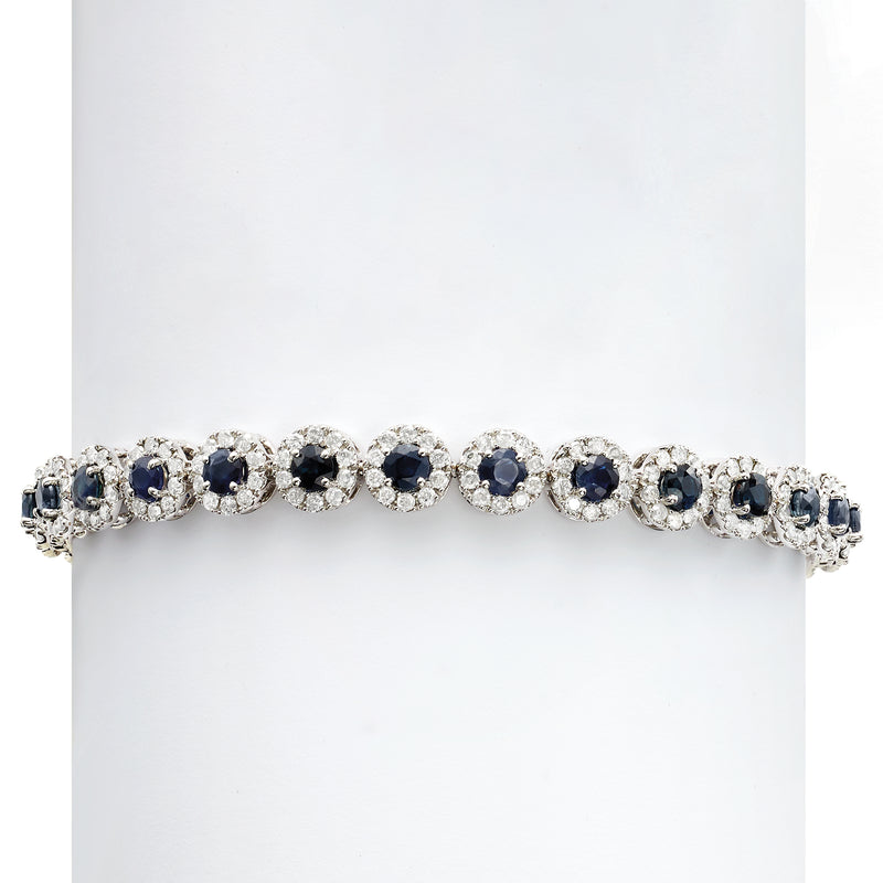 Tennis bracelet with alternating blue sapphire and round diamond clusters in white gold
