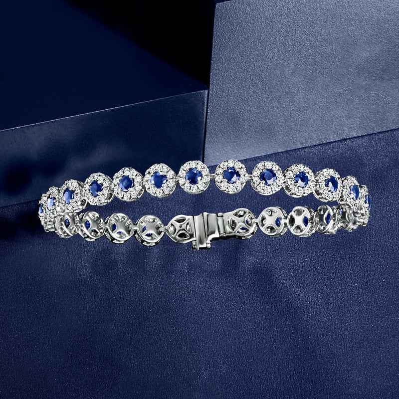 White gold tennis bracelet with blue sapphire stones and diamond pave accents