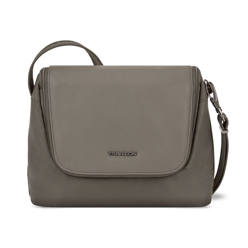 Brown anti-theft crossbody bag with front flap, logo, and zipper closure