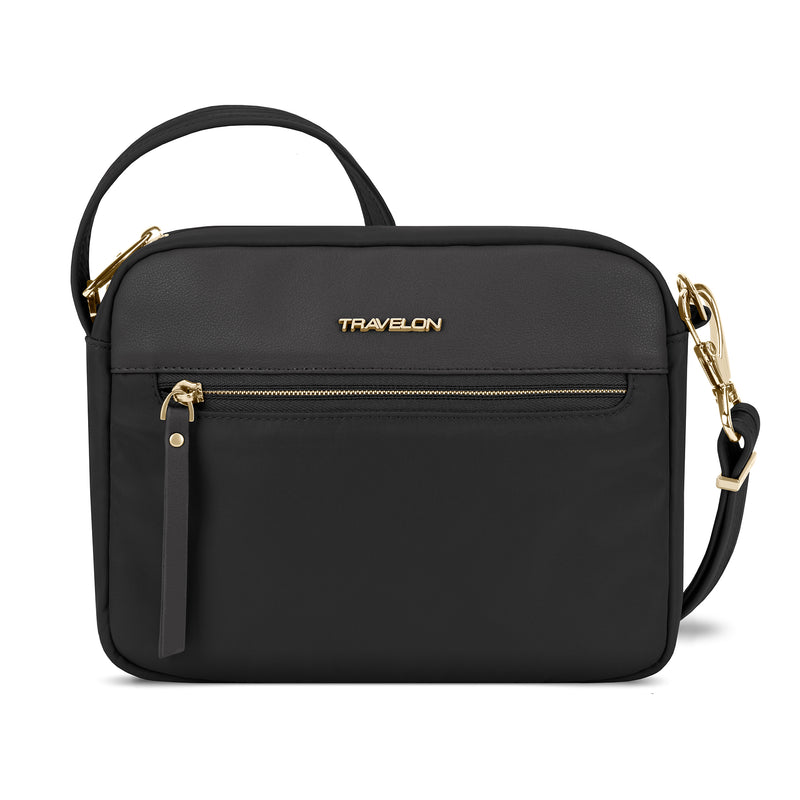 Small black crossbody bag with front flap, dual zippers, and gold hardware, TRAVELON logo