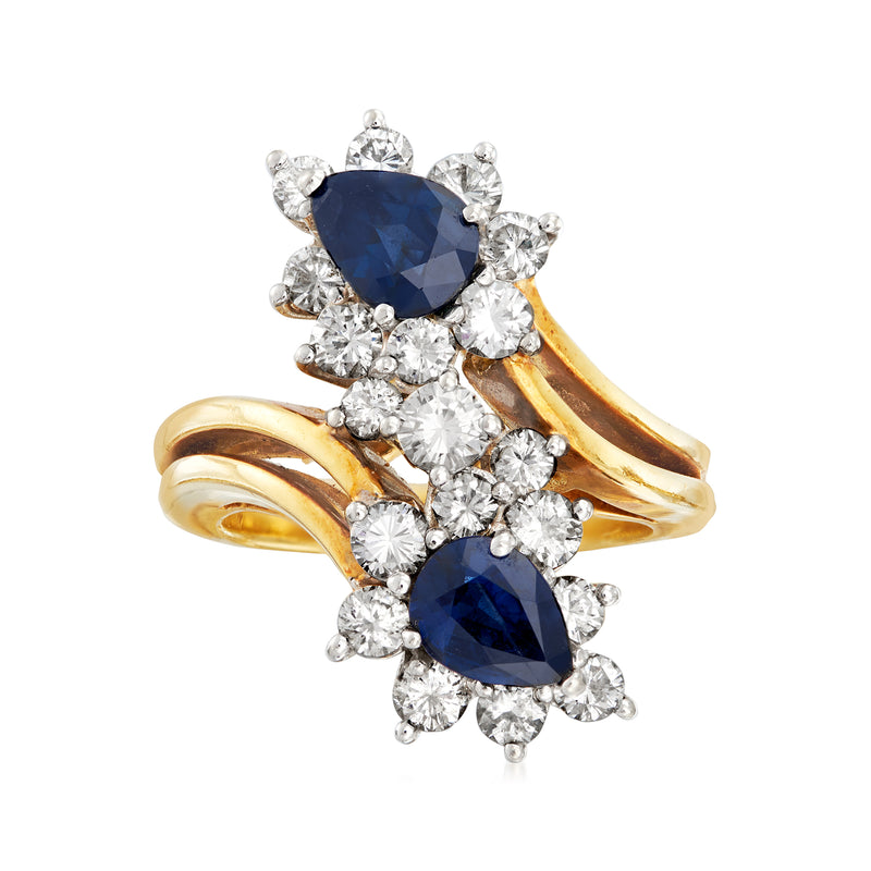 18kt yellow gold bypass ring with dark blue oval sapphires and diamond accents
