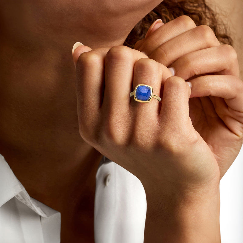 Lapis blue square ring on finger, gold-tone band with bezel-set stone