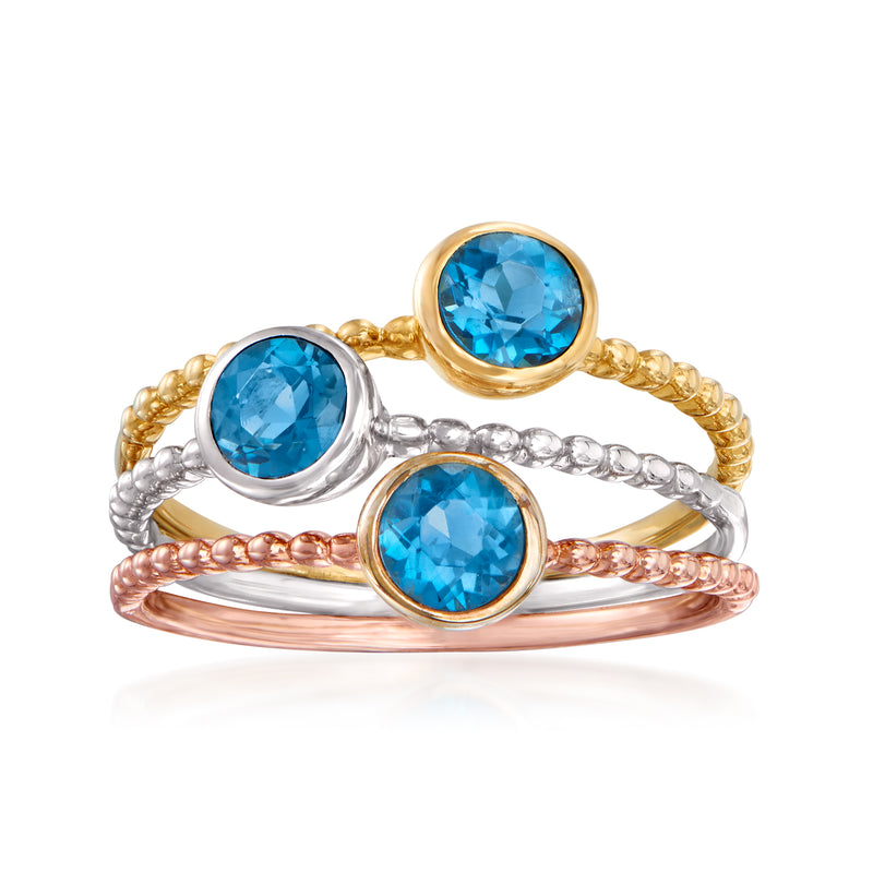 Three-ring jewelry set with round blue topaz stones in gold and silver bands