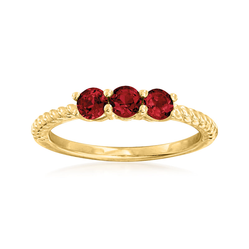 Three-stone garnet pinky ring with round red stones on 18kt gold over sterling band