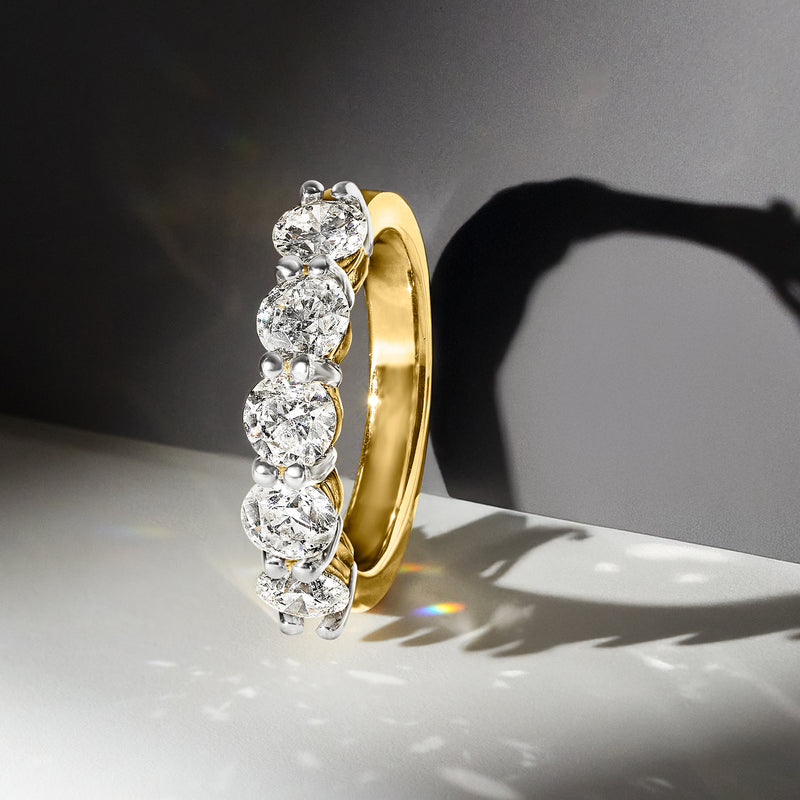 Five-stone diamond ring in 14kt yellow gold with five round diamonds in raised bezels