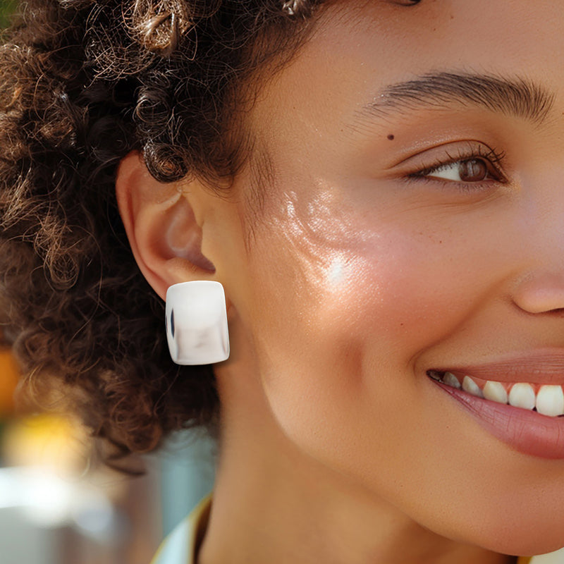 Sterling silver square clip-on earring on model ear with polished finish