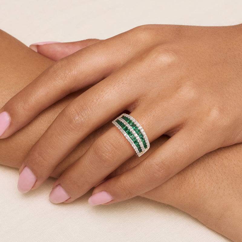14kt yellow gold dome ring worn on hand with emerald-green and diamond multi-row bands