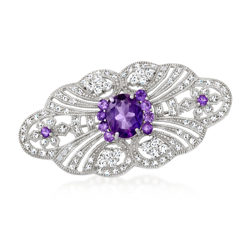 Sterling silver openwork pin with amethyst oval center and purple stones, jeweled border.