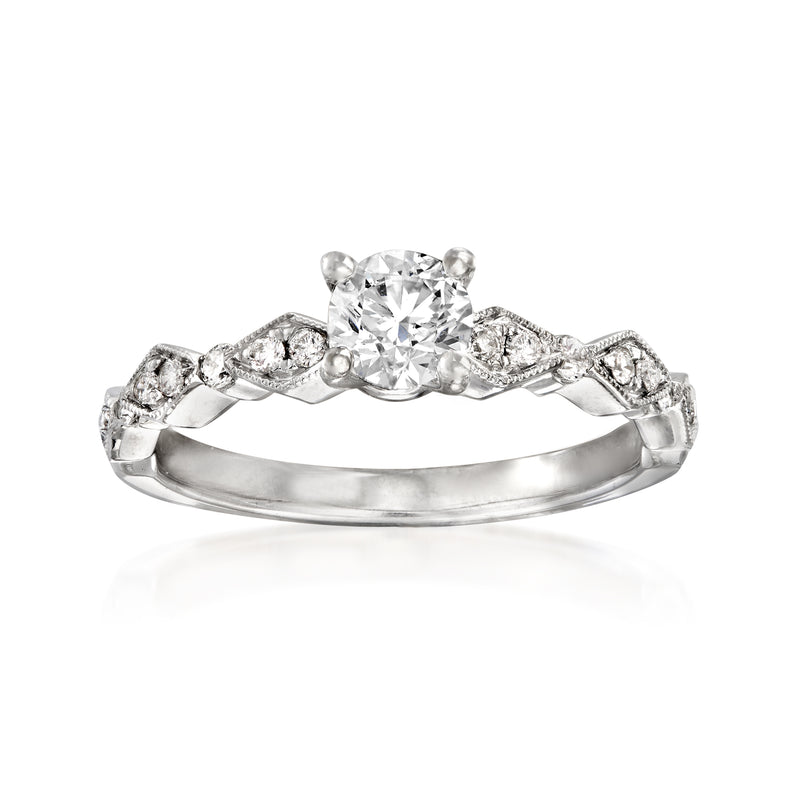 Diamond engagement ring in 14kt white gold with round center stone and pavé band