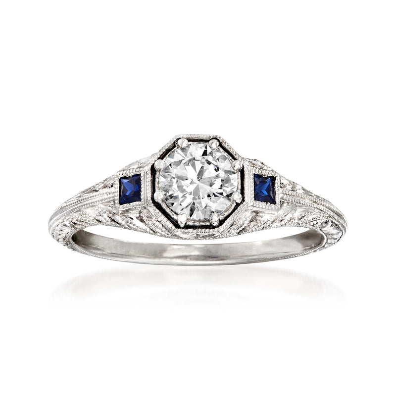 14k white gold engagement ring with round diamond center and two blue sapphire accents