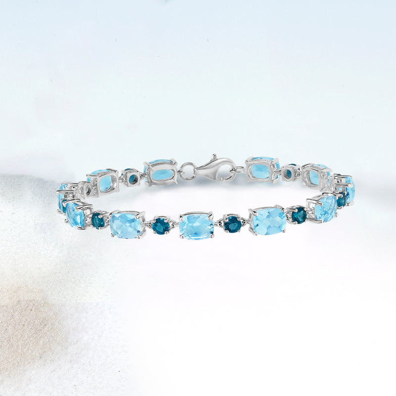 Sterling silver blue topaz tennis bracelet with oval light blue stones and round blue accents