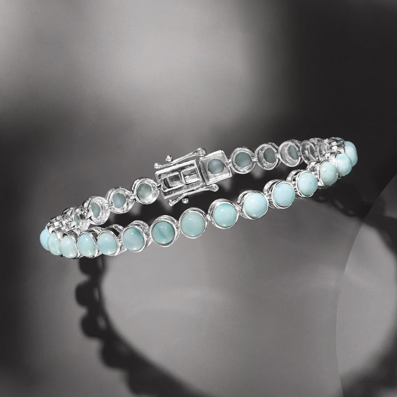 Sterling silver tennis bracelet with oval Larimar stones and hinged clasp detail