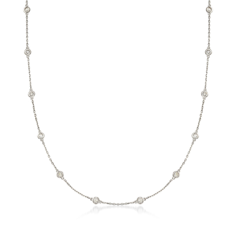 Sterling silver diamond station necklace with bezel-set round diamonds on a fine chain