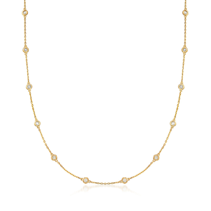 Gold station necklace with bezel-set round diamonds along a fine chain